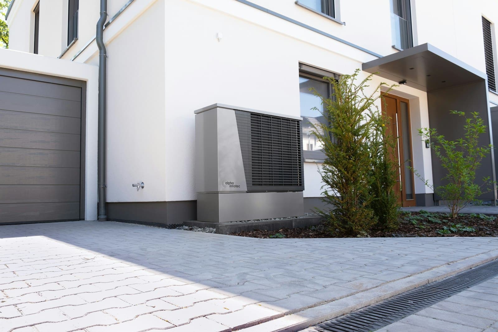 Modern heat pump unit installed outside a contemporary home